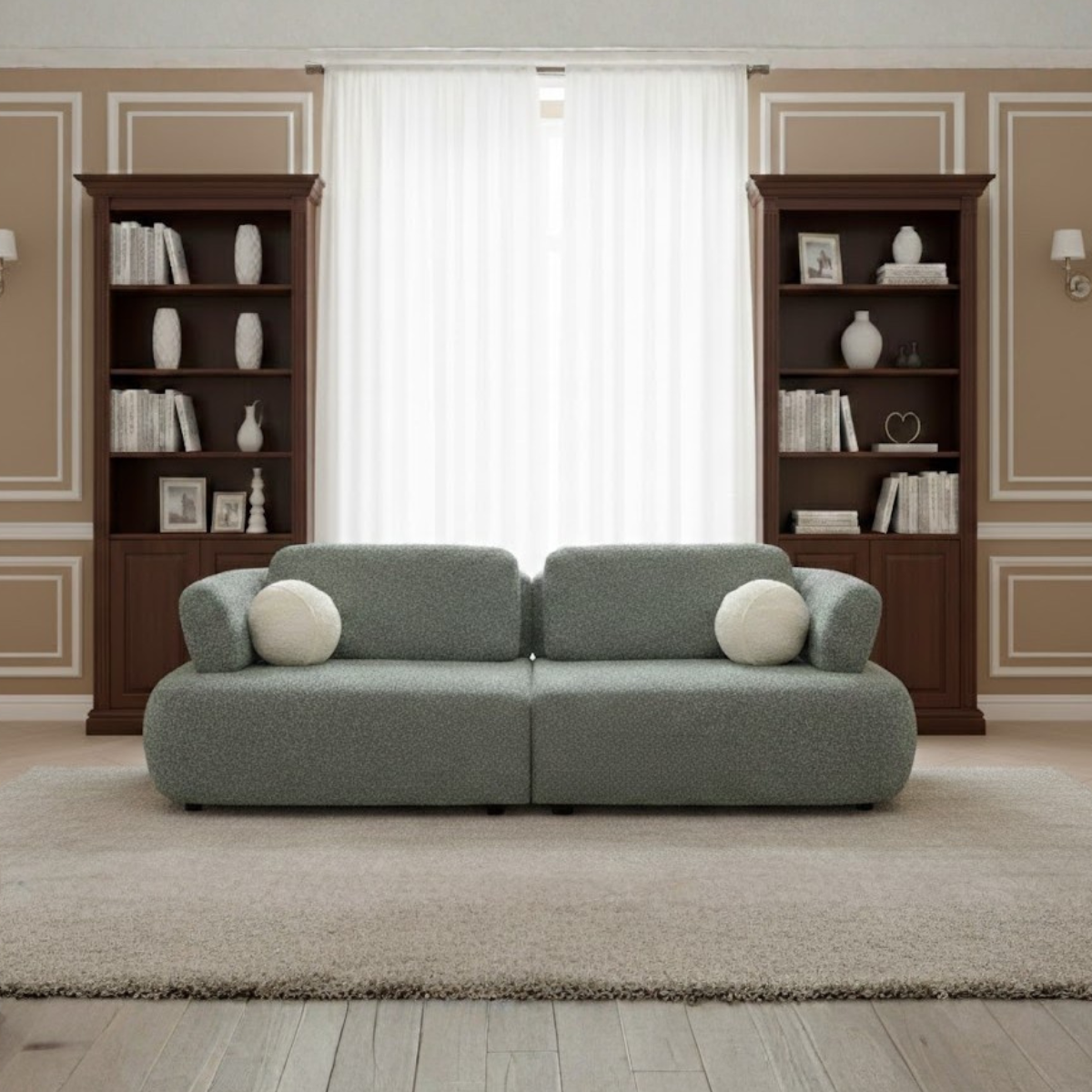 Gray sofa with white cushions in a room with wooden bookshelves and a window.