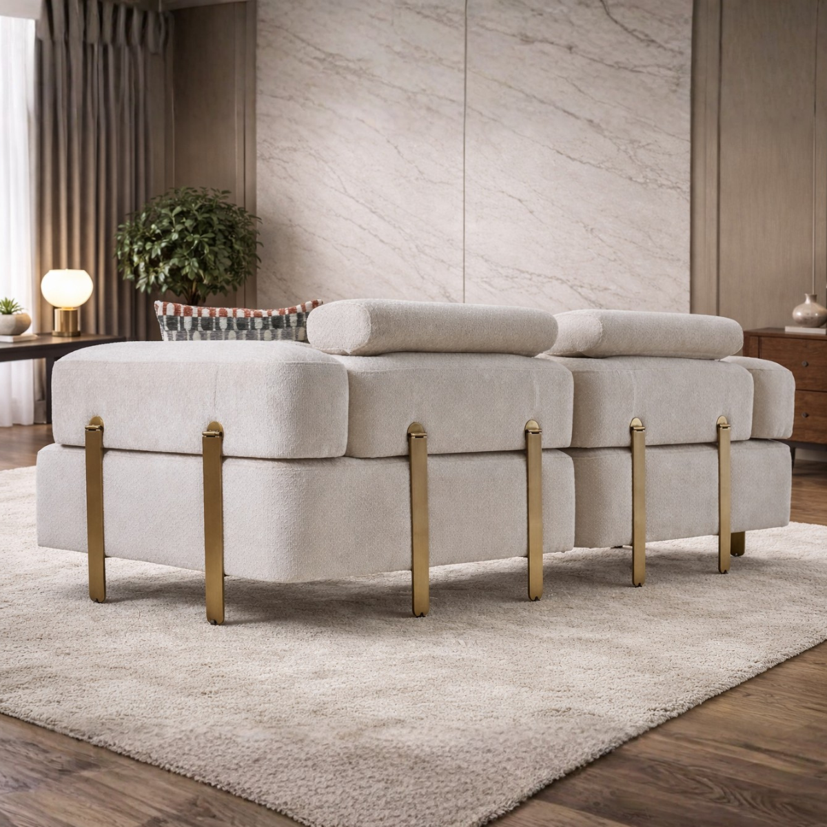 Gray ottoman with gold legs in a living room setting