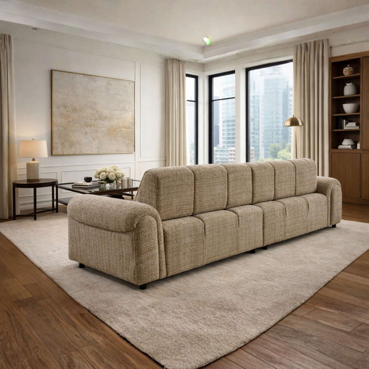 Beige sofa in a modern living room with large windows and decor.