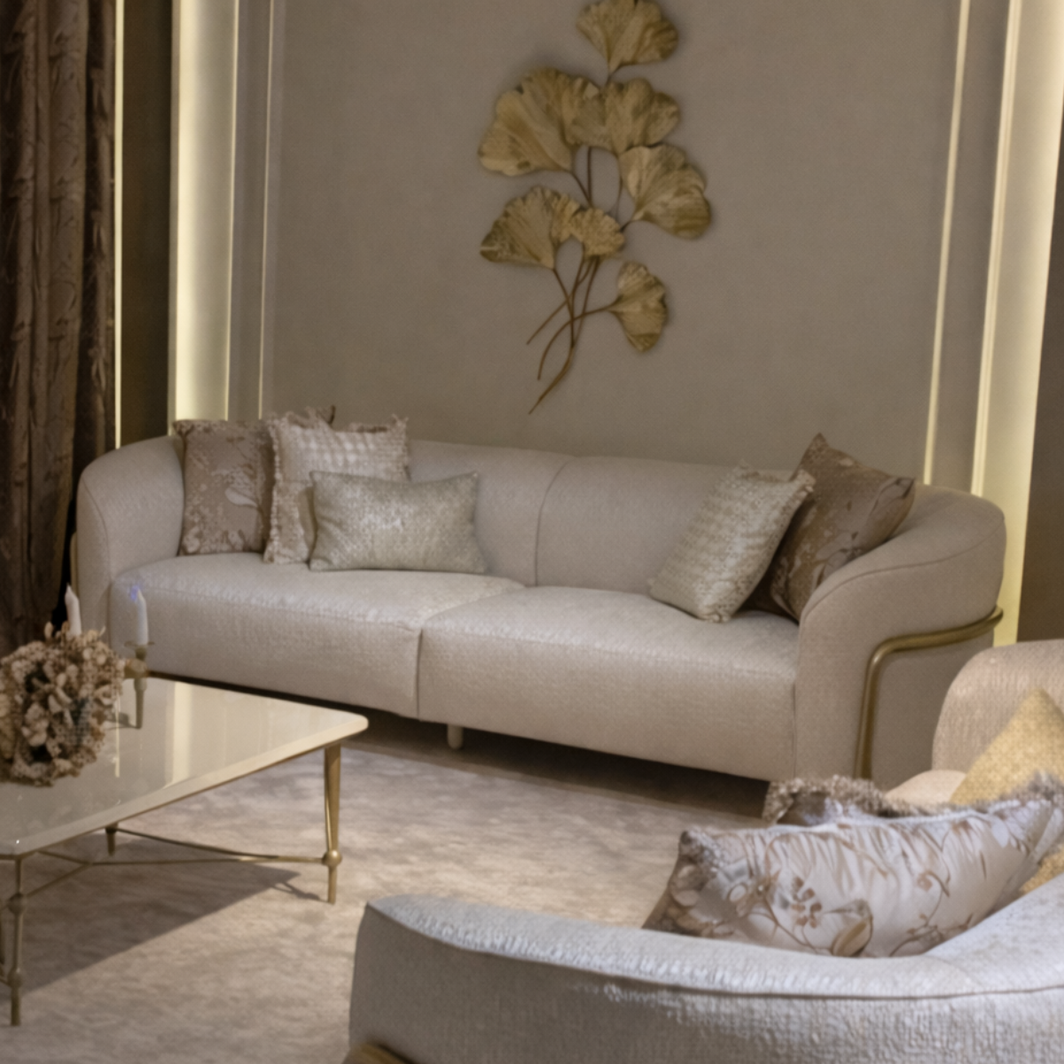 Beige sofa with decorative pillows in a stylish living room setting.