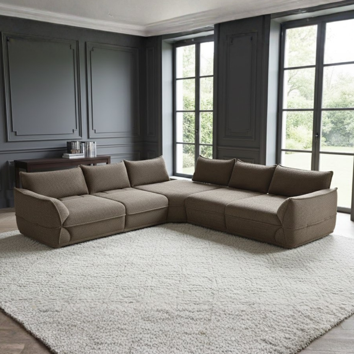 Brown sectional sofa in a room with large windows and dark walls.