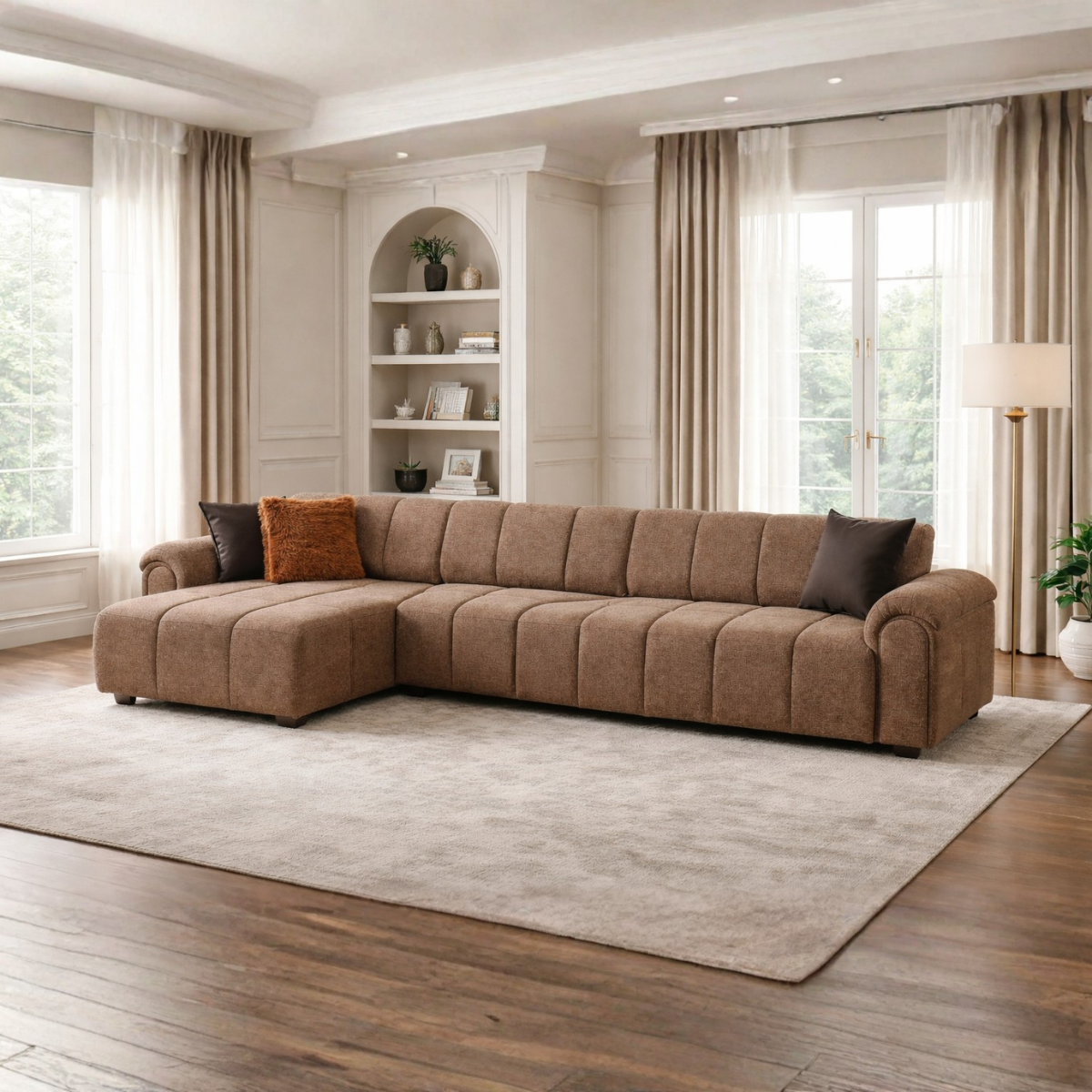 Brown sectional sofa in a living room with large windows and neutral decor.
