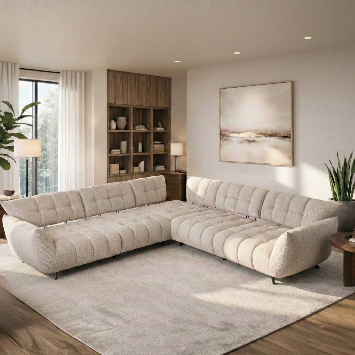 Modern living room with a beige sectional sofa, bookshelf, and artwork.