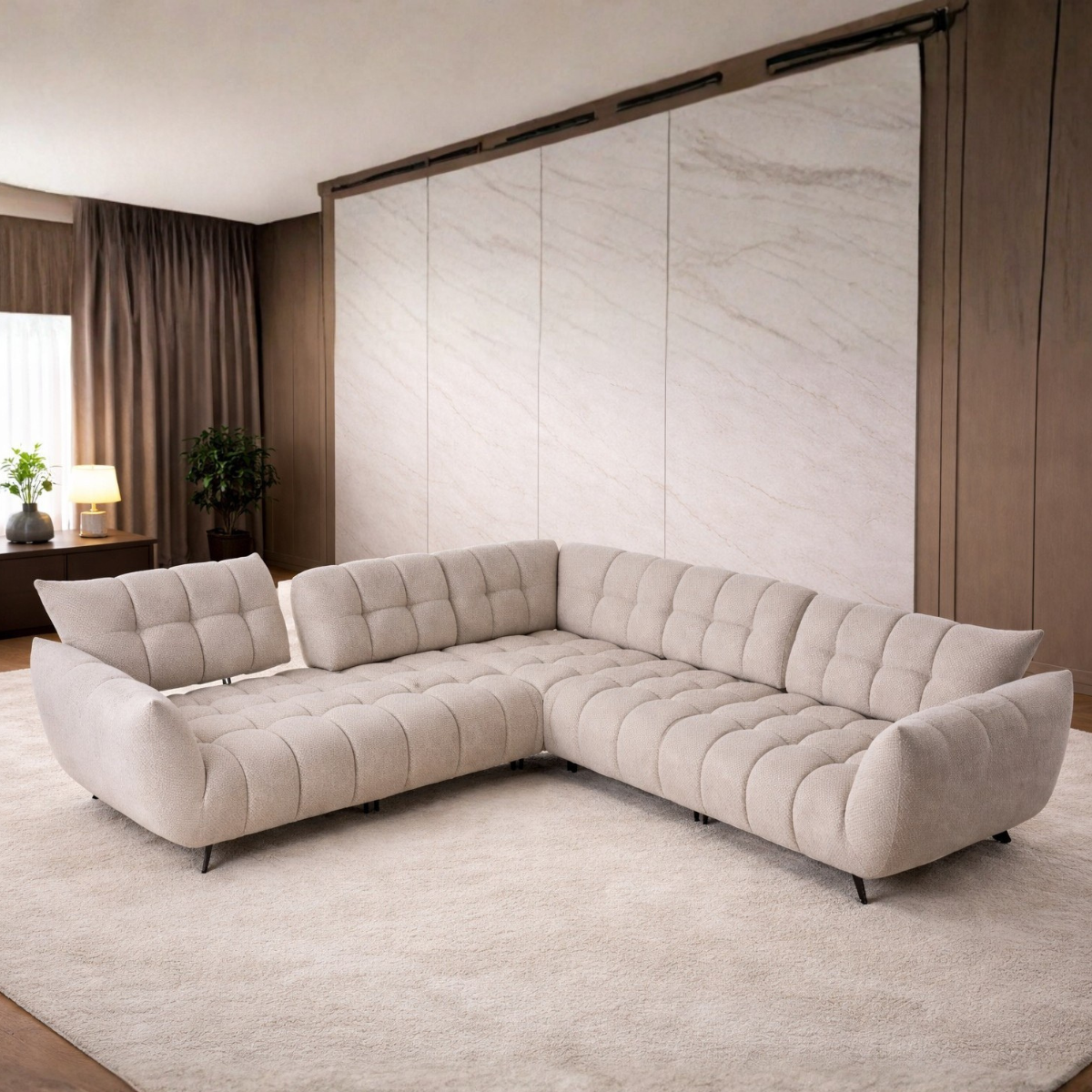 Beige sectional sofa in a modern living room with marble wall.