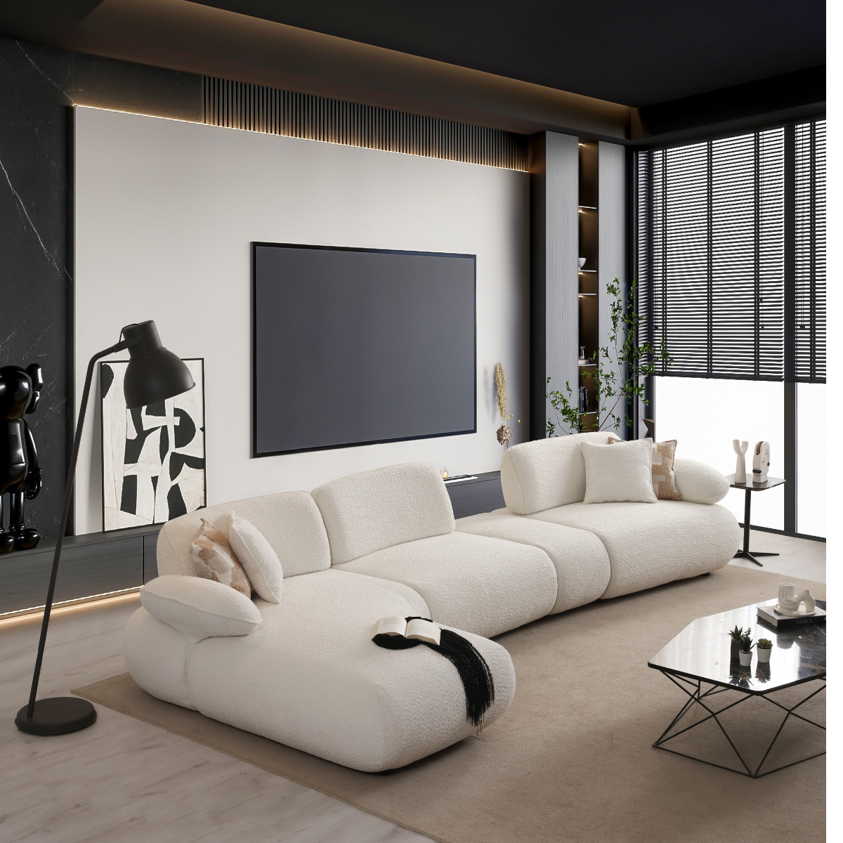 Modern living room with a white sofa, coffee table, and wall-mounted TV.