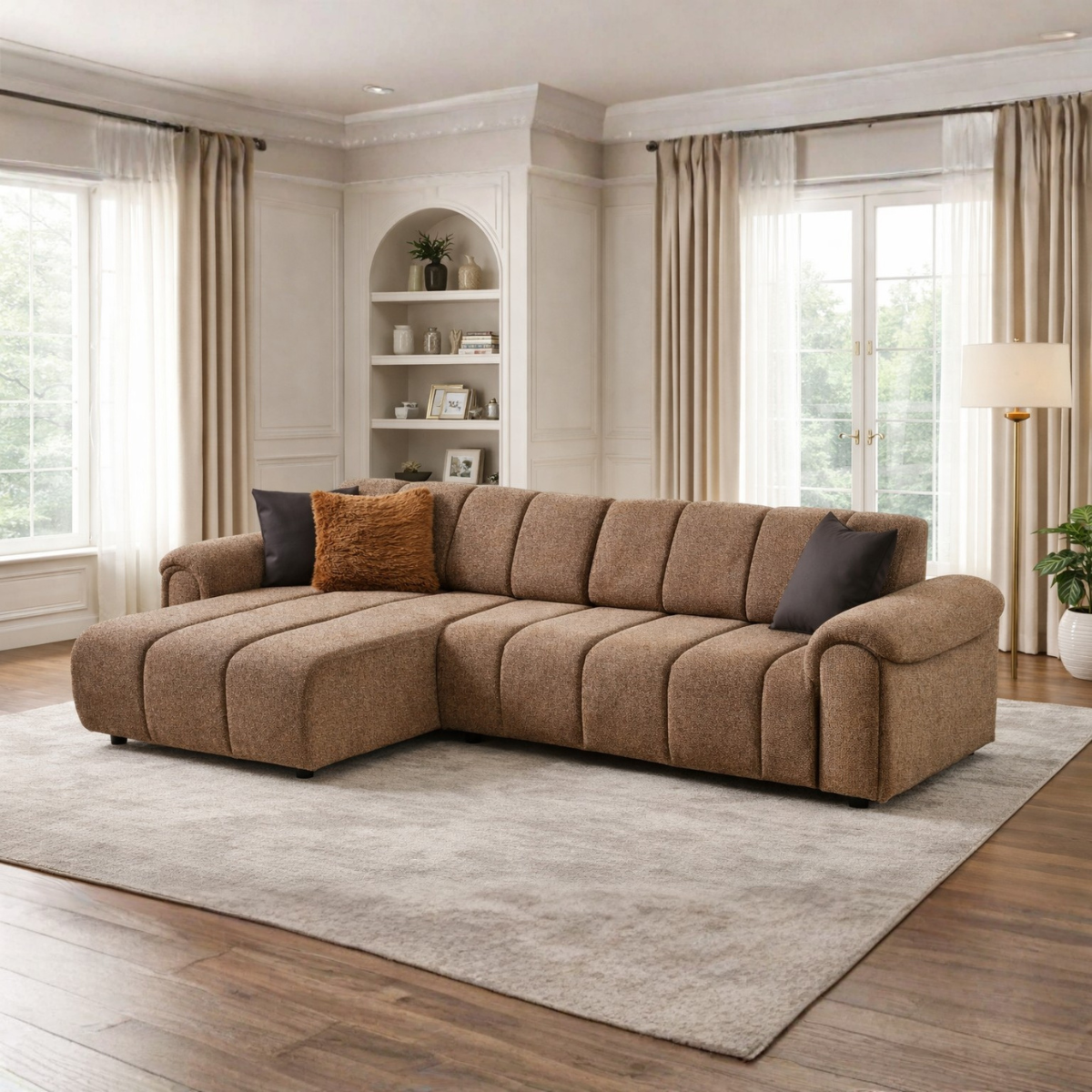 Brown sectional sofa in a living room with large windows and a rug.