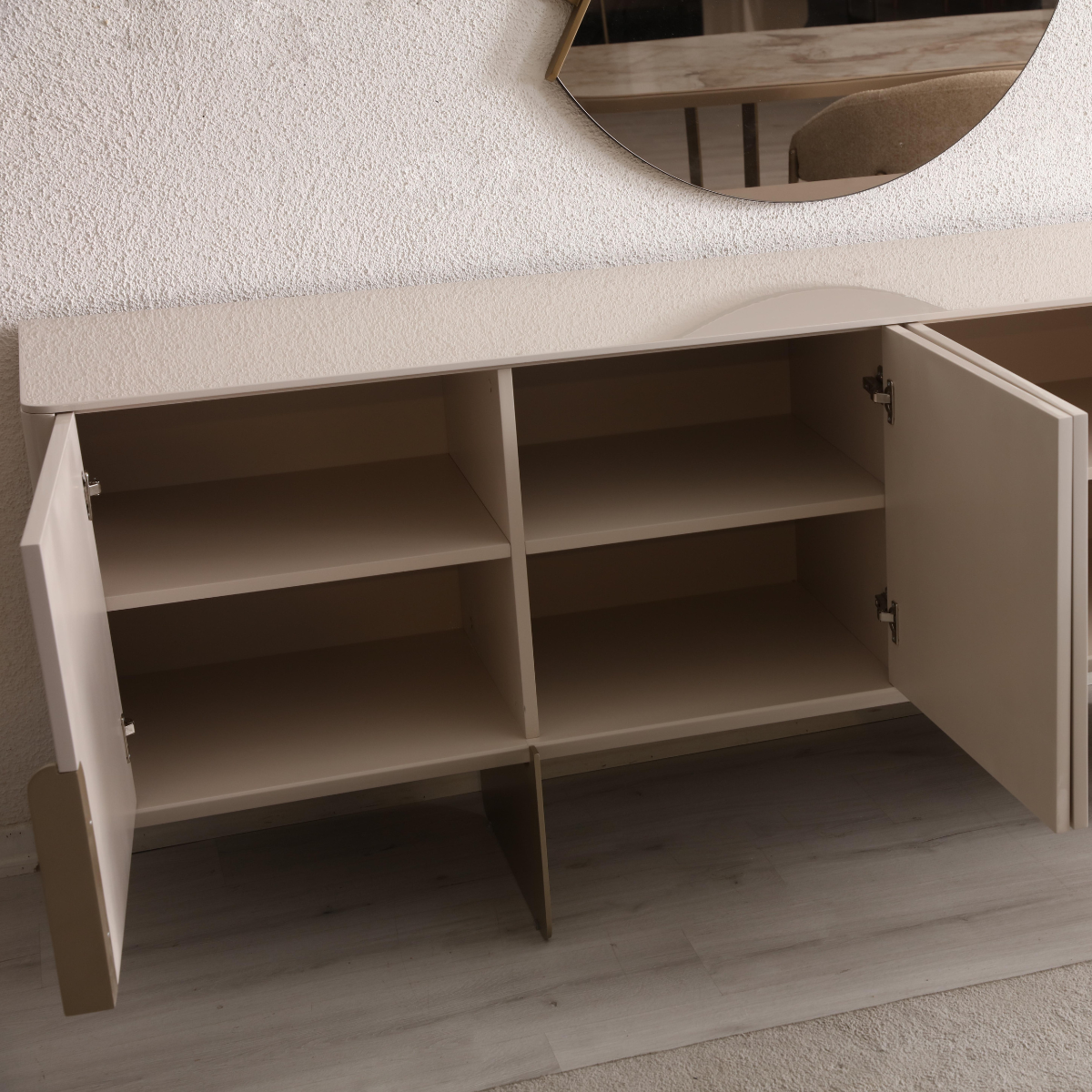 Beige sideboard with open doors on a light wooden floor.