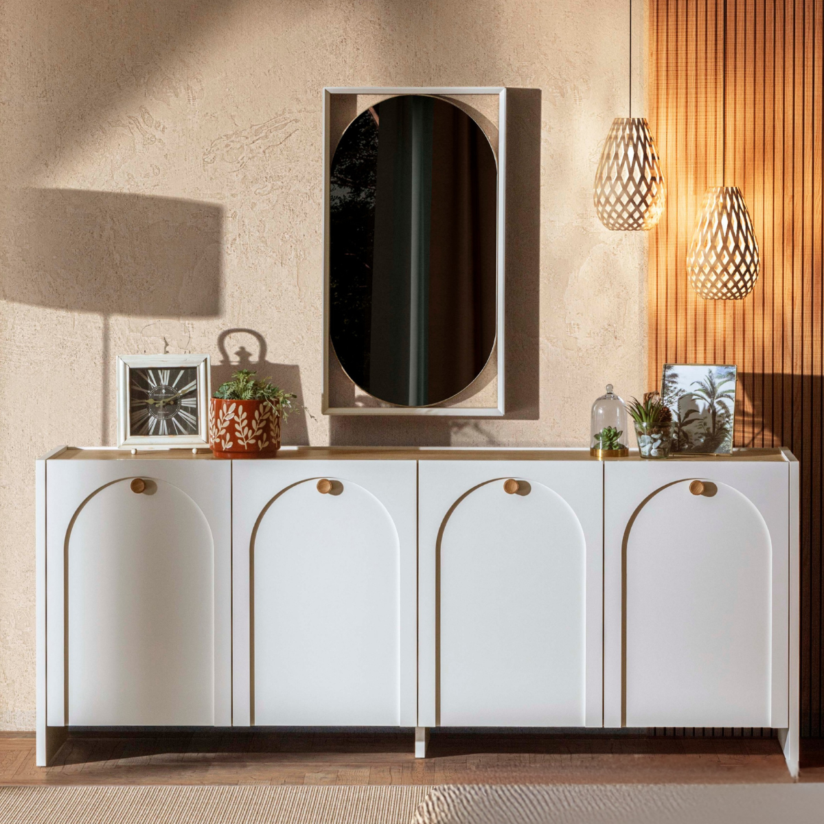 White sideboard with decorative items against a beige wall.
