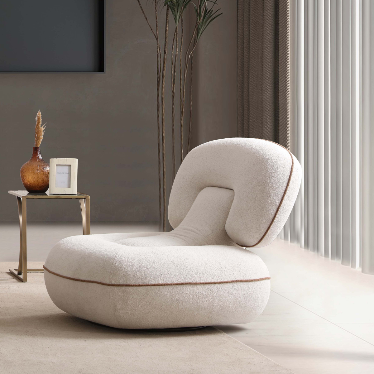 Modern white chair in a minimalistic room with a side table and plant.