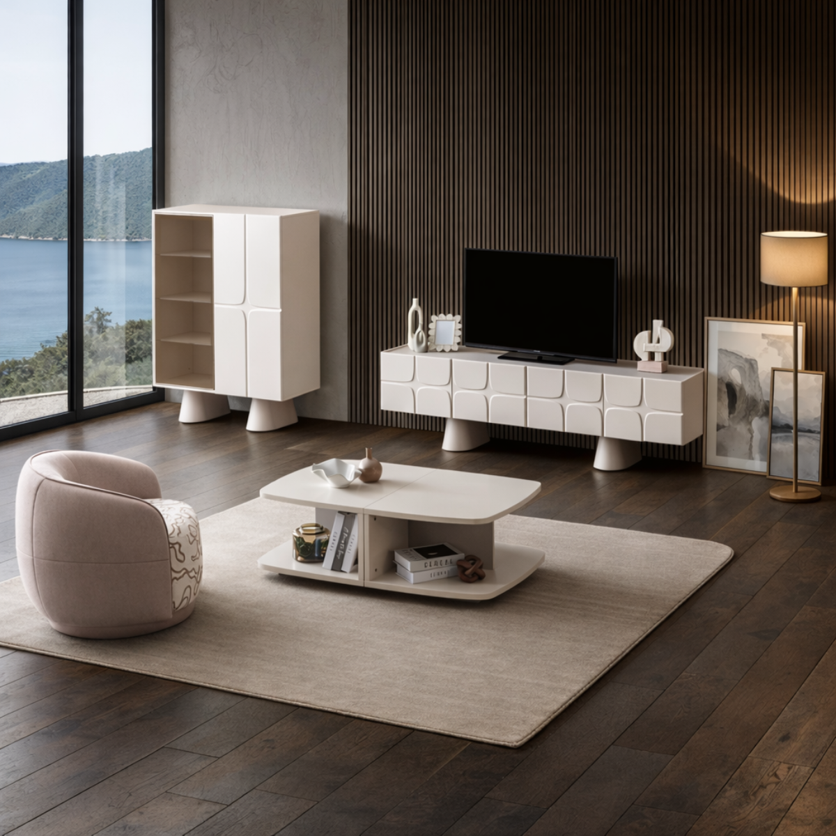 Modern living room with white furniture, TV stand, and armchair by a large window with a view of water.