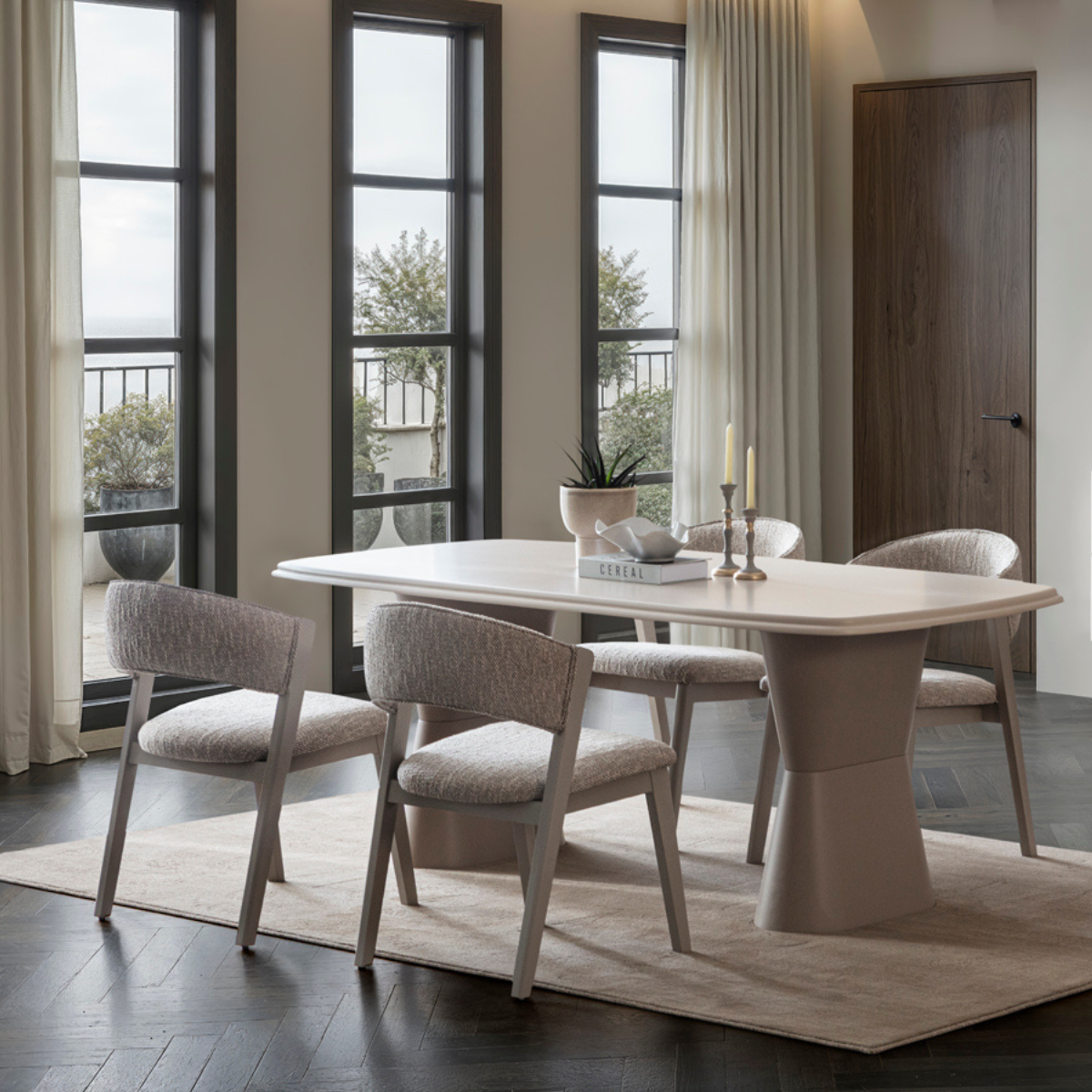 Dining room with a modern table and chairs in a well-lit room.