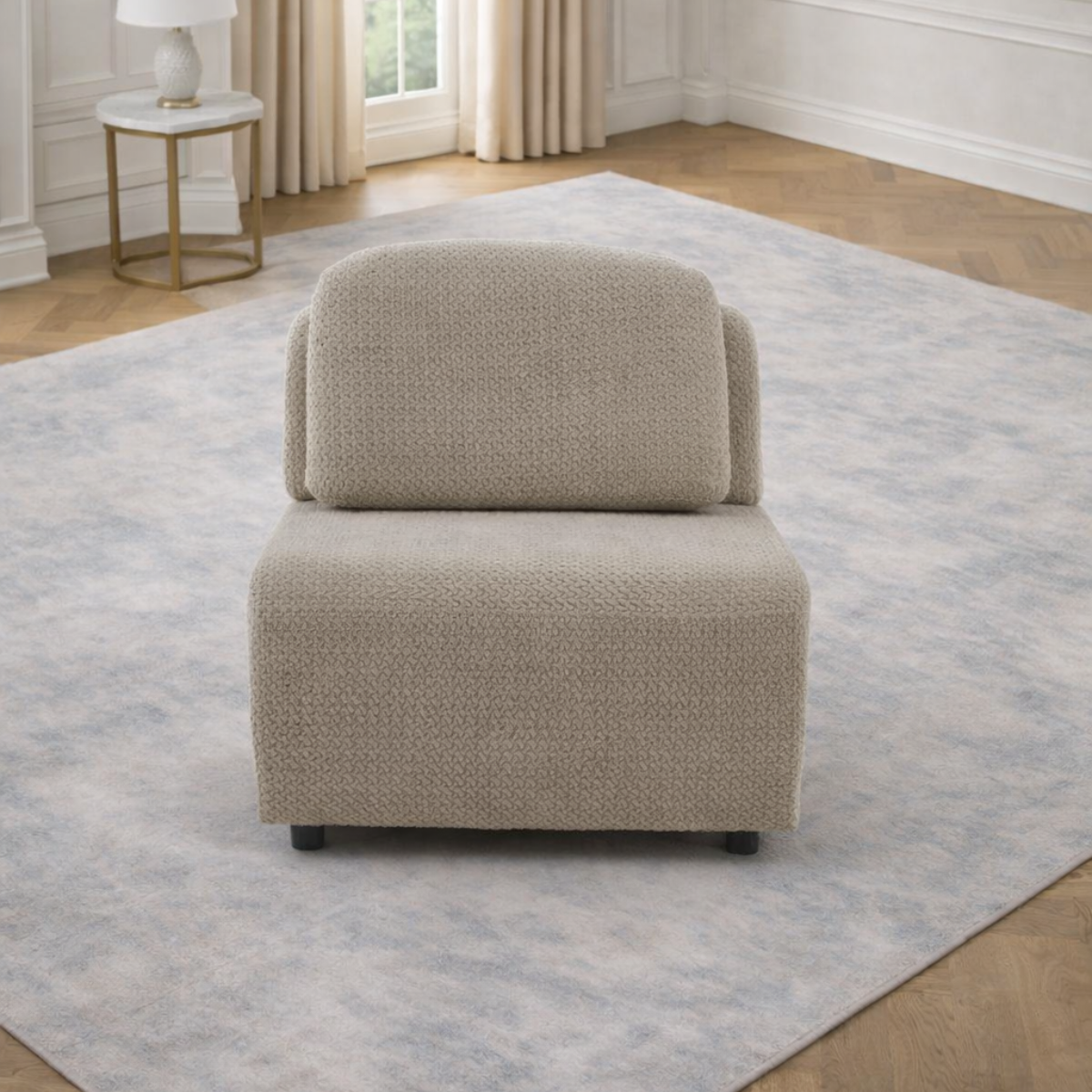 Beige armchair on a light gray rug in a room with a window and side table.