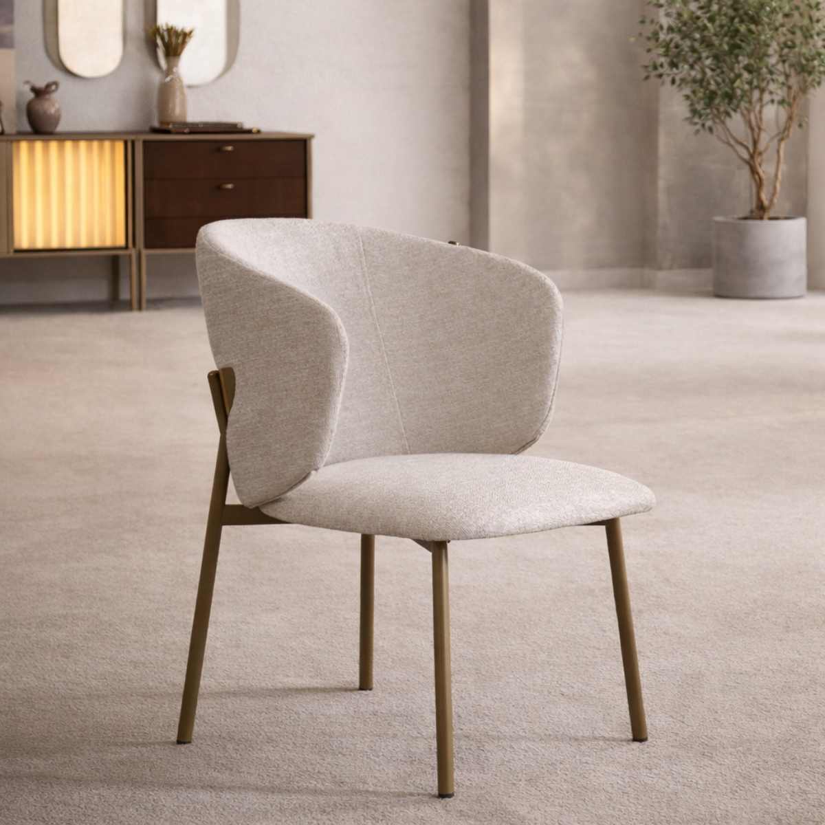 Modern beige chair in a room with a wooden cabinet and plant
