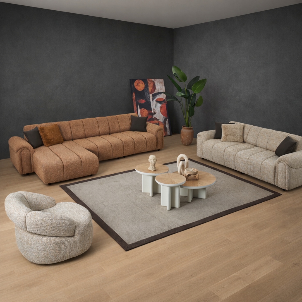 Modern living room with brown and beige sofas, a round coffee table, and decorative items.
