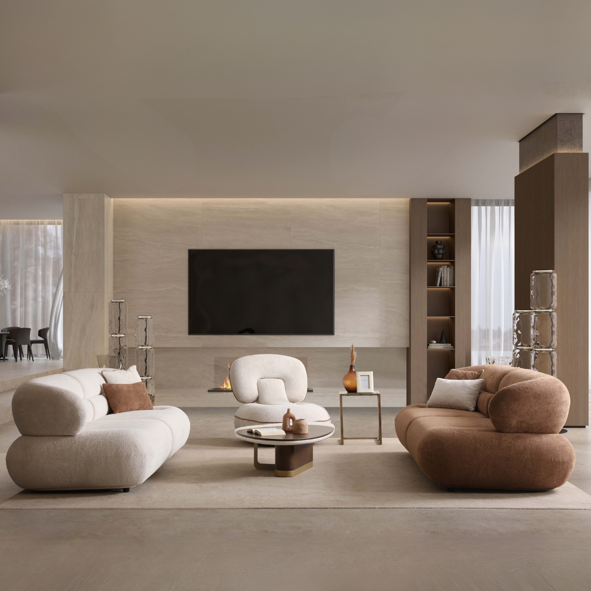 Modern living room with beige and brown furniture, TV, and shelves.
